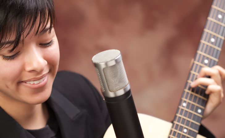 Smiling Woman Plays Guitar