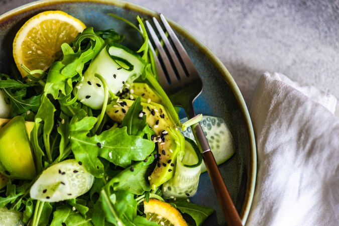 Close up top view of healthy vegetable salad with arugula and avocado