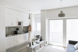 Pensive serene woman having refreshment with water in comfortable kitchen