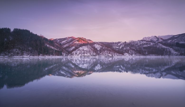 Gramolazzo lake and snow in Apuan mountains in winter after sunset, Garfagnana, Italy