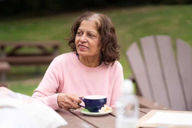Woman sitting outside sipping tea