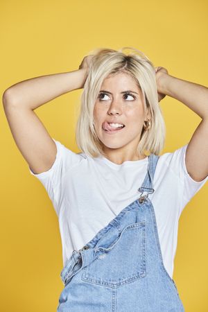 Trendy blonde female in denim sundress