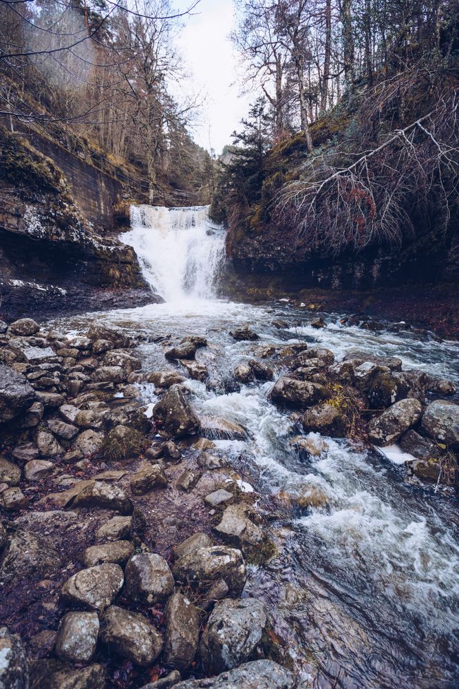 Cascade mountain river at autumn forest