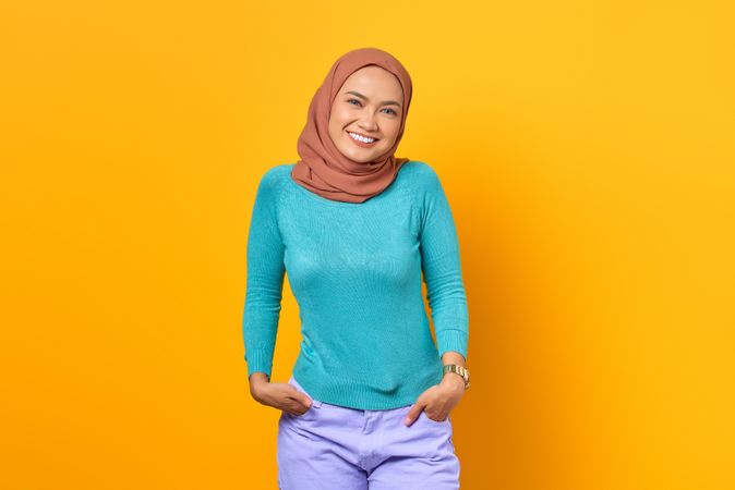 Muslim woman smiling with hands in pockets