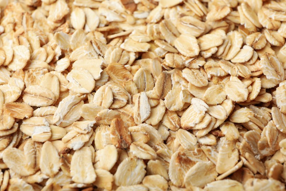 Oatmeal flakes texture on whole background, close up