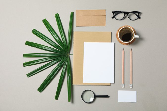 Mockup. Corporate stationery, glasses and palm leaves on grey background. Flat lay