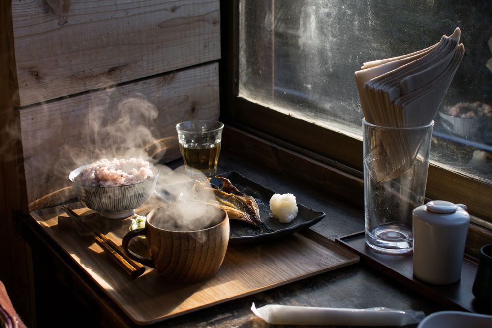 Hot dishes beside glass of water on a tray