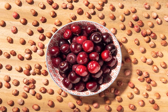 Fresh sweet cherries in bowl and cherry seeds