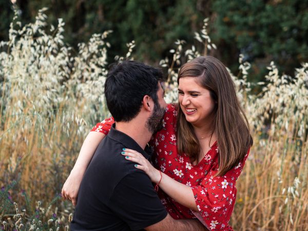Young happy couple embracing in beautiful garden