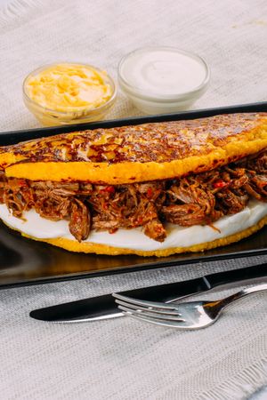 Cachapa, typical Venezuelan dish made with corn and stuffed with cheese and grilled meat