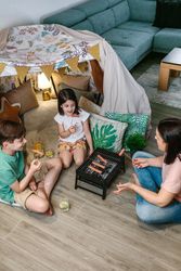 Top view of family grilling and eating sausages on barbecue