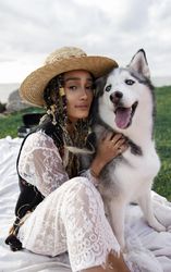 Woman sitting beside husky outdoor