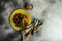 Top view plate of grilled chicken with rosemary with copy space