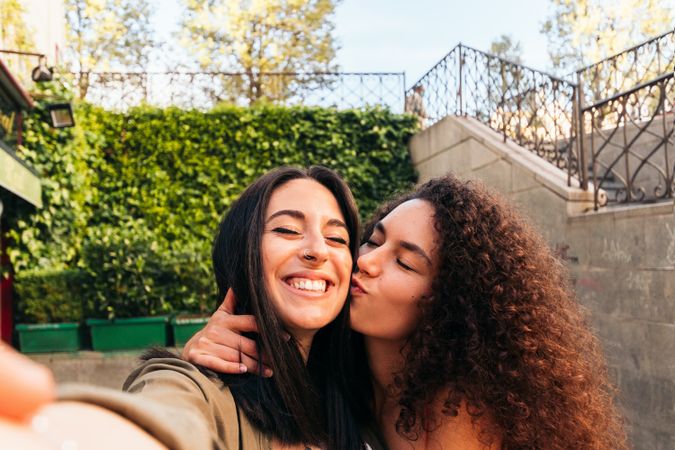 stylish women couple selfie kissing on the cheek
