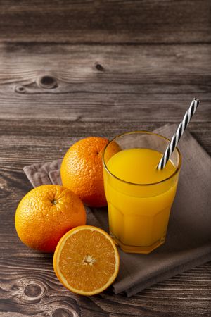 Glass with orange juice on the table.