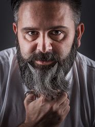 Expressive barber cutting beard