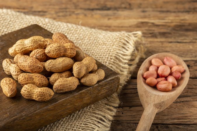 Dry peanut on the wooden background.