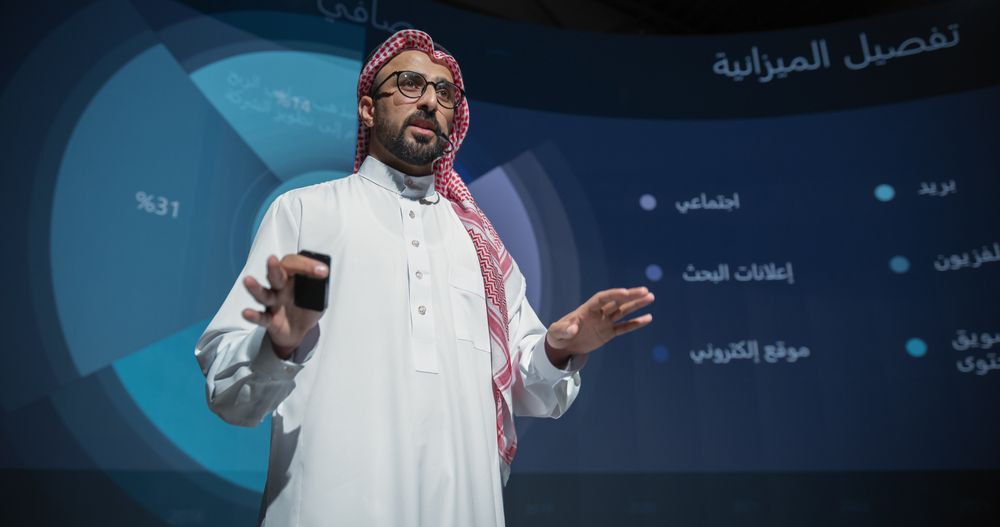 Saudi Businessman Making a Presentation on Stage During a Middle Eastern Business Conference.
