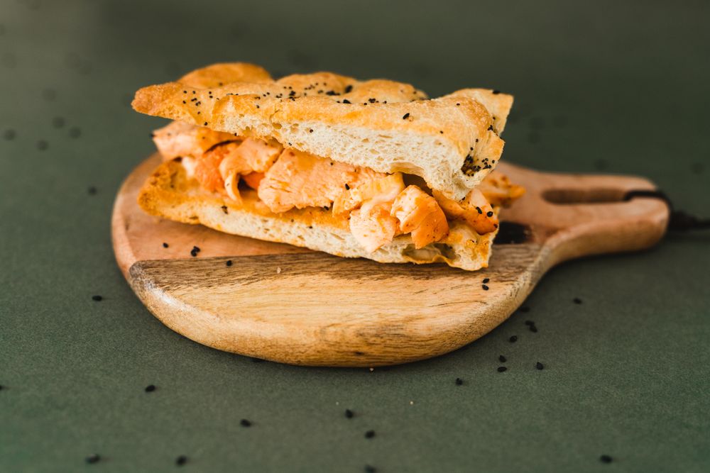 Flat bread sandwich on wooden cutting board