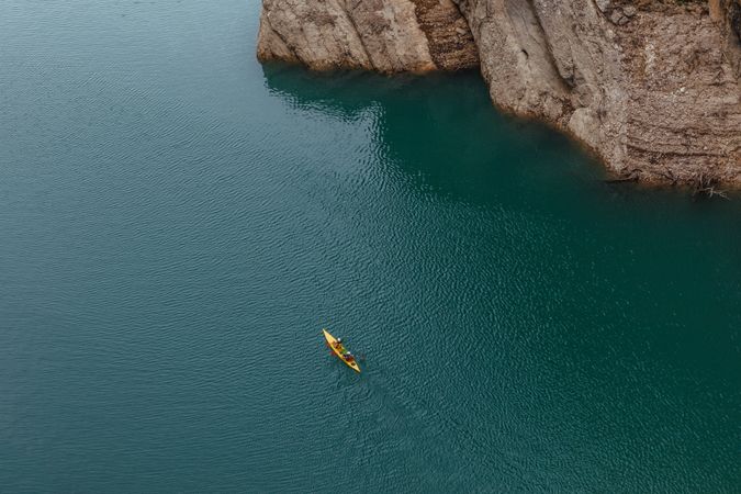 People crossing a river by kayak
