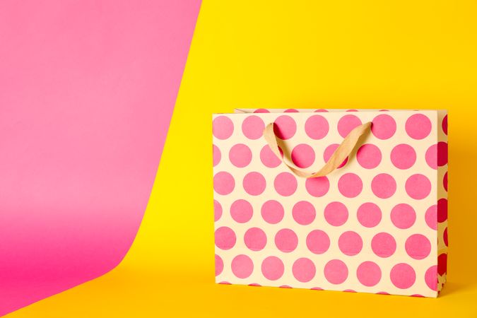 Paper bag on multicolor background, space for text