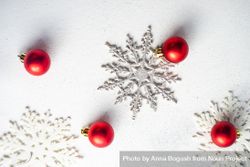 Top view of decorative snow flakes and red baubles bePe34