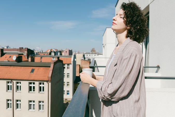 Elegant woman enjoying sun at terrace