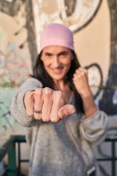 Smiling female in bandana hitting camera and smiling