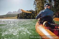 Rear view image of a man canoeing in a lake 47NZz5