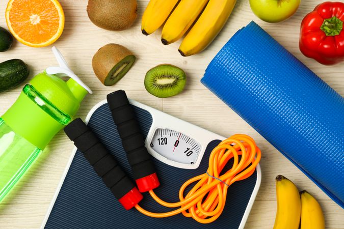 Healthy lifestyle accessories on wooden background, top view