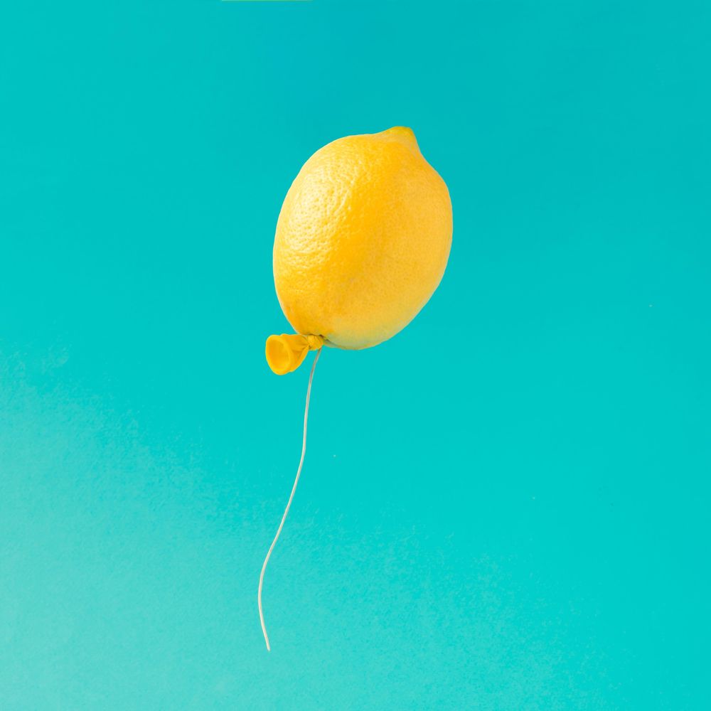 Lemon balloon on bright blue background