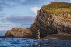 Woman on paddleboard floating in sea