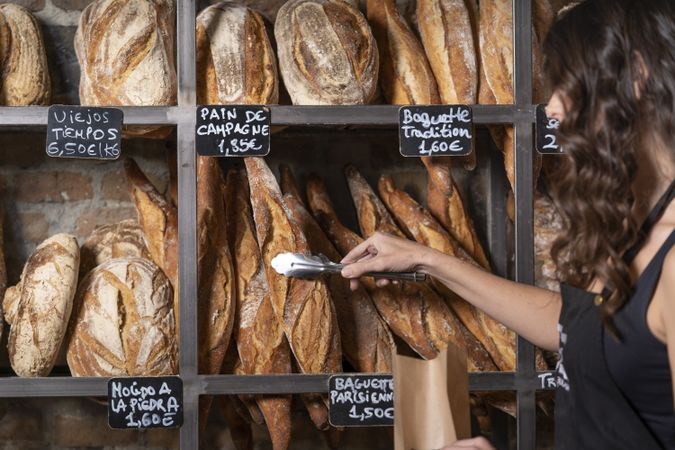 Young female selling baguettes