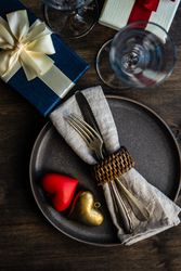 Grey plate with heart decorations and silverware