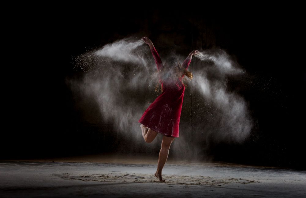 Young woman between fog in darkness