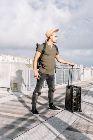 man going to summer trip and walking with his suitcase.