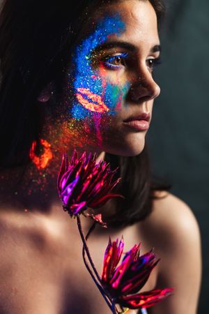 Young woman covered with uv painting
