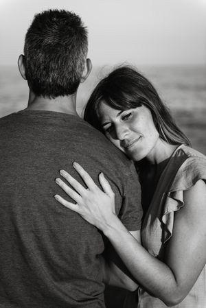 Adult couple embracing near sea