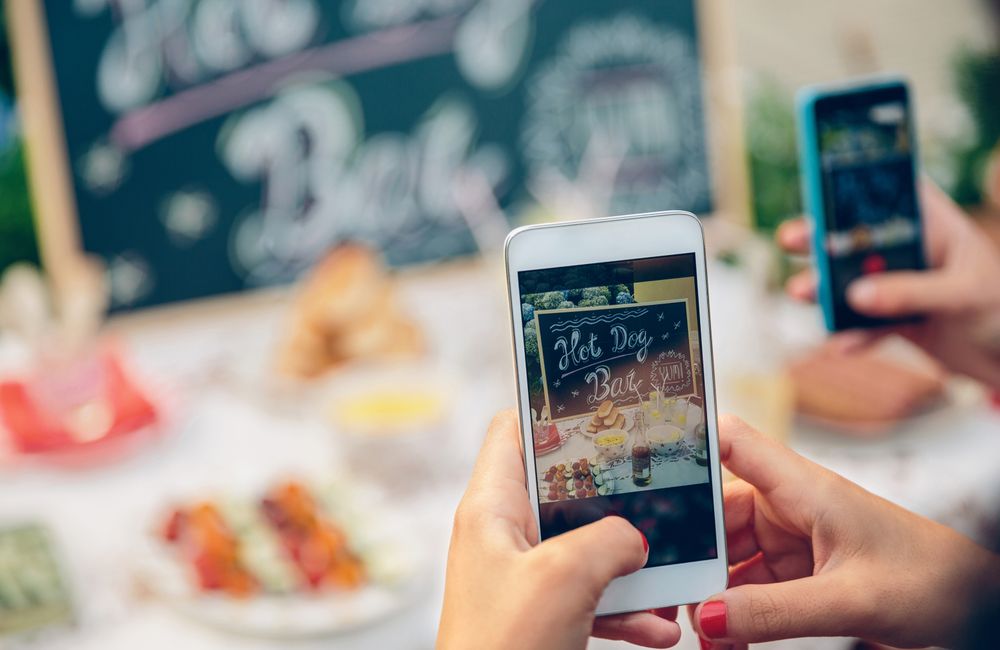 Woman hands taking photo to table with food