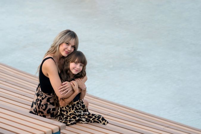 Mom hugs little daughter for a walk