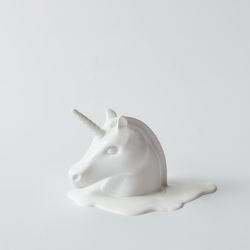 Painted unicorn head on light flat background