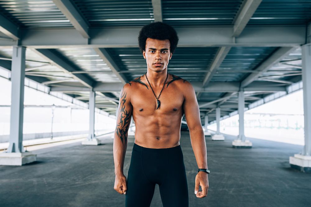 Black male athlete standing in underpass