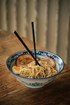 Bowl with appetizing ramen served on table