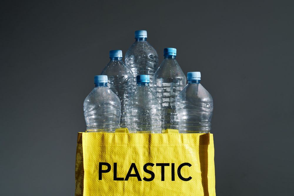 Plastic bottles in yellow bag for recycling