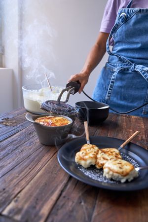 Faceless person cooking delicious fried dessert