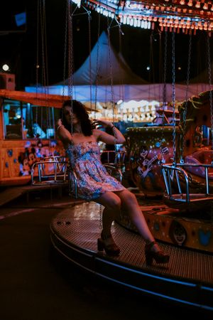 Woman enjoying ride on carousel