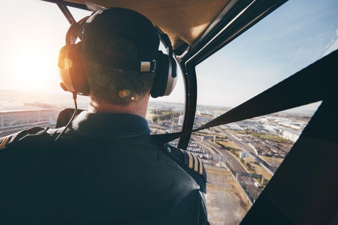 Pilot flying an aircraft over a city