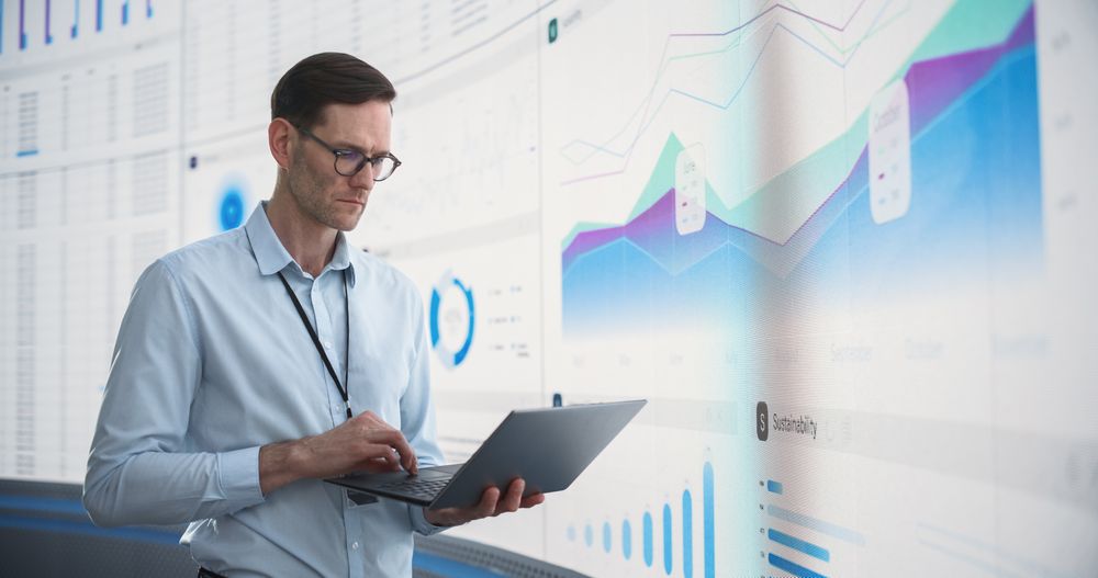 Successful Man Assessing Risks And Developing Strategies For Company Growth, Expansion.