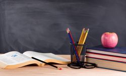 Desk in classroom ready to learn from textbooks