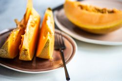 Side view of sliced orange melon